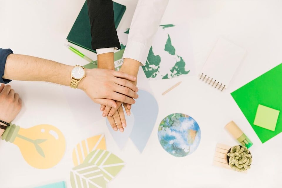 group-businesspeople-stacking-their-hands-desk_23-2147826610
